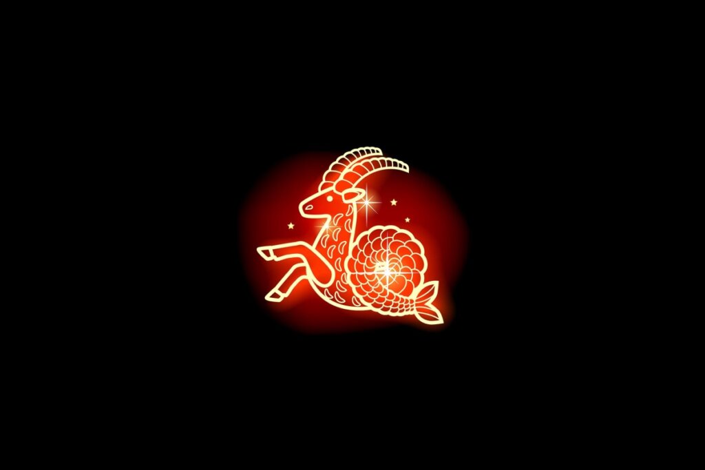 Ilustração em vermelho neon do signo de Capricórnio em um fundo preto 