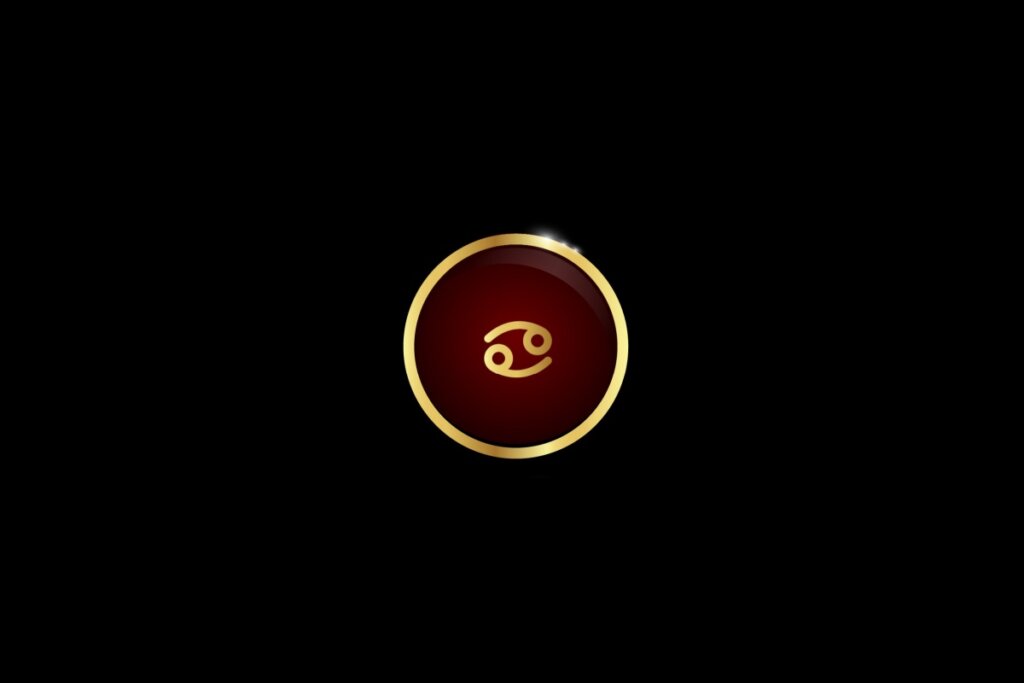 Ilustração do signo de câncer dentro de um círculo dourado, iluminado com uma luz vermelha, em um fundo preto