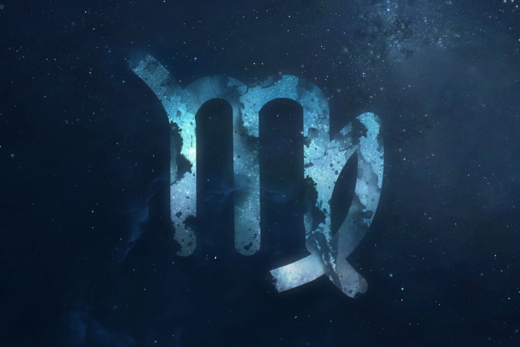 símbolo do signo de virgem em um fundo azul marmorizado sobre fundo azul-escuro estrelado